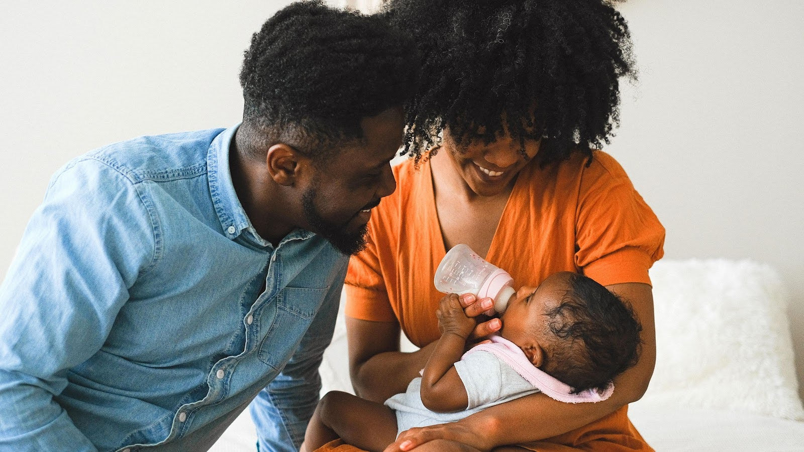couple feeding baby
